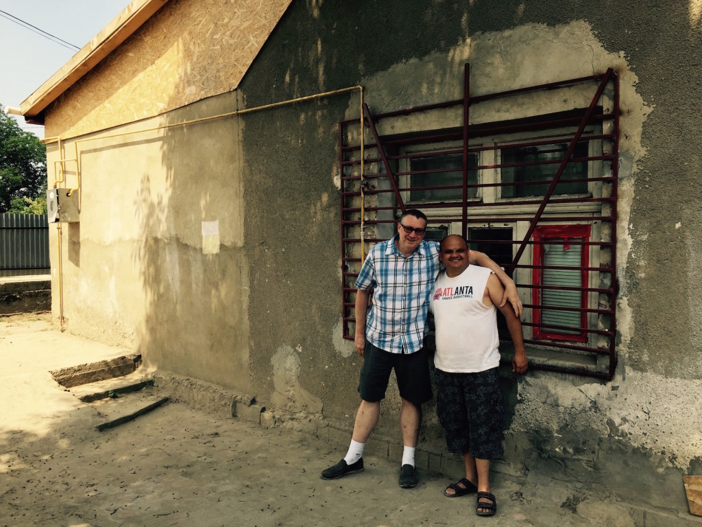 Doug and Roma pastor outside church, where on Sunday it's standing room only